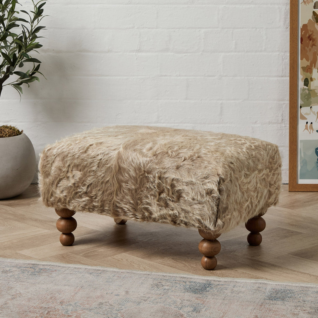 This Leather Footstool Layout Trick Hides Everyday Clutter